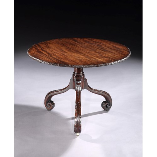A mahogany tripod table
